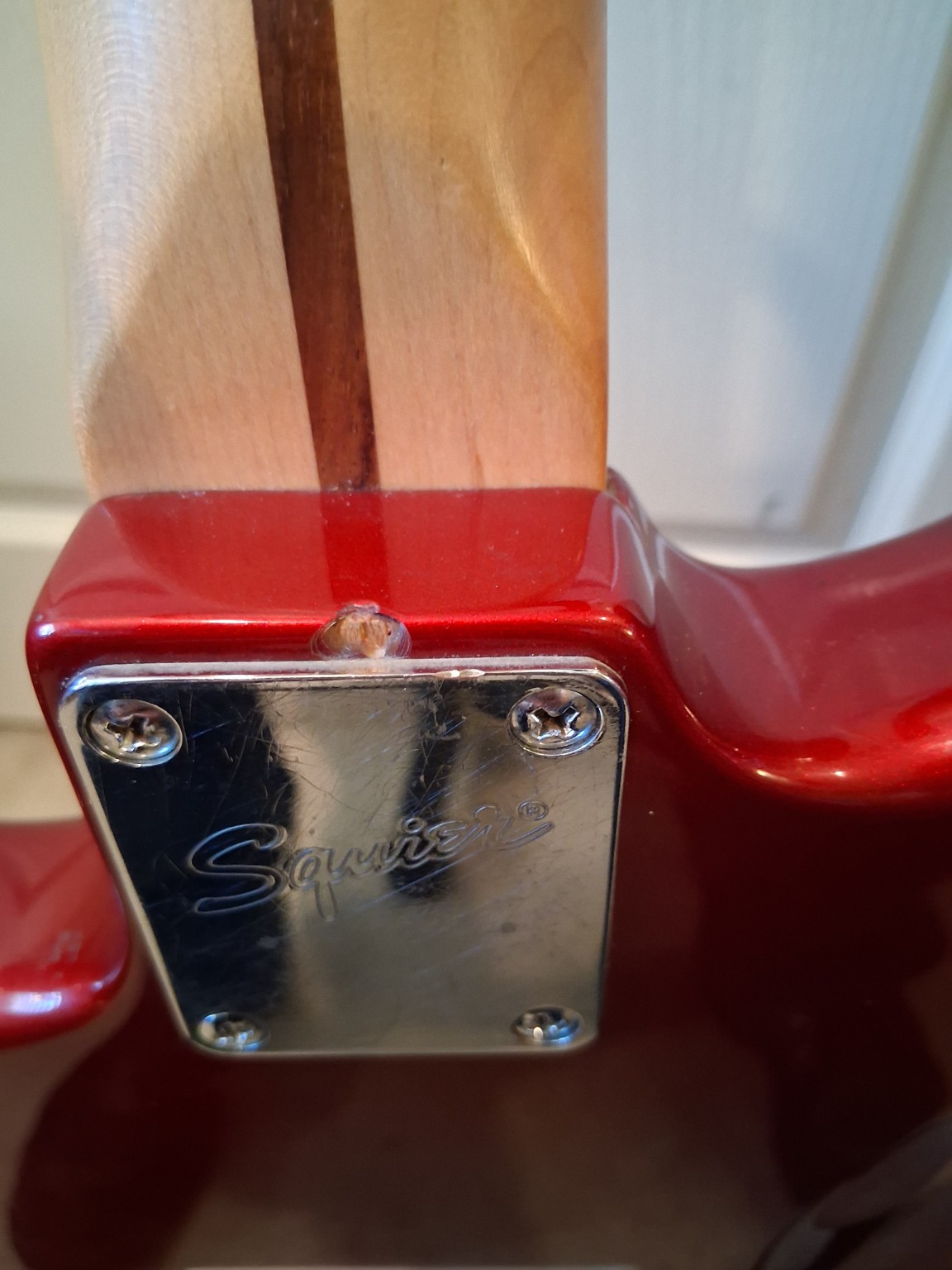 Small cosmetic mark near neck plate